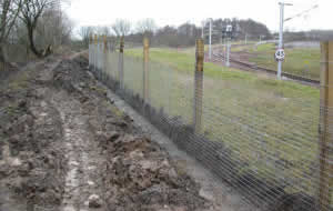 Muddy terrain next to train tracks